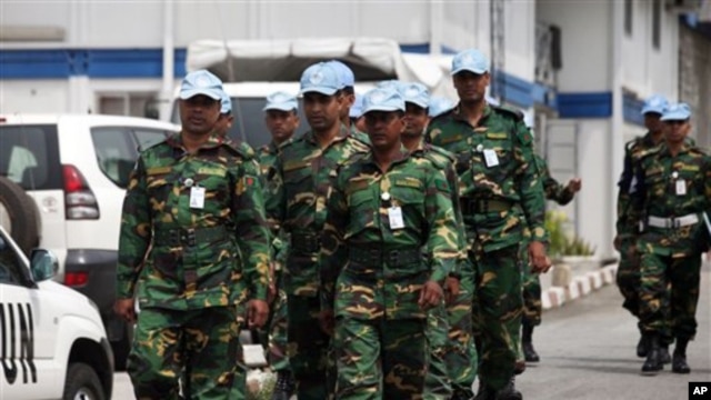 UN troops walk inside the UN Headquarters in Abidjan, Ivory Cost, Friday, Dec. 31, 2010. The United Nations is warning supporters of incumbent leader Laurent Gbagbo that an attack on the hotel where the internationally recognized winner of last month's el