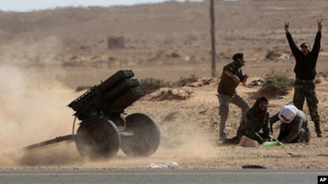 Libyan rebels fire multiple launcher rockets during a fight against pro-Gadhafi fighters near the town of Bin-Jawad, eastern Libya, Sunday, March 6, 2011.