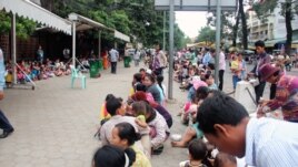 People with their small children are waiting out side Kuntha Bopha hospital in Phnom Penh, Cambodia.