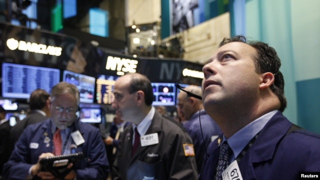 Traders work on the floor of the New York Stock Exchange, October 23, 2012. 