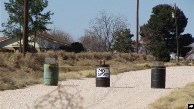 The driveway to the Shatto family home, rear left, is seen in Gardendale, Texas, March 1, 2013.