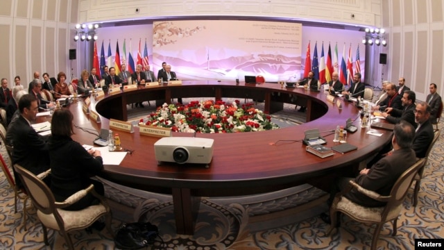 Participants sit at a table during talks on Iran's nuclear program in Almaty, February 26, 2013.