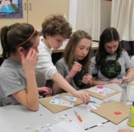 Pennsylvania students create quilt patches bearing their pledges to save the environment.
