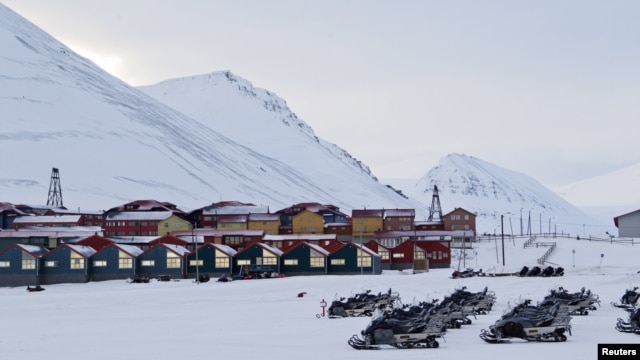 Snow scooters are seen parked in the town of Longyearbyen in Svalbard, March 26, 2012.   