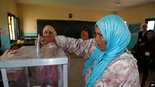 A woman casts her ballot at a polling station in Rabat, November 25, 2011.