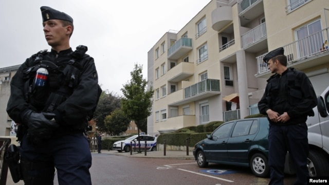 French gendarmes secure a garage entrance, where an anti-terrorist raid was conducted four days ago, in Torcy near Paris, October 10, 2012.