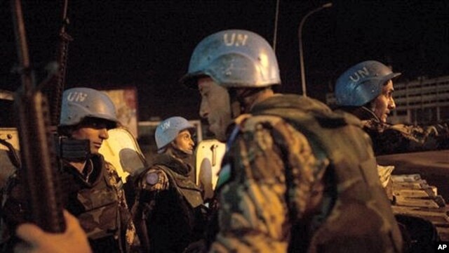 UN peacekeepers from Jordan provide security at night on the streets of Abidjan, Ivory Coast, April 4, 2011