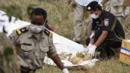 Police officials collect skulls and bones thought to be of Laurent Vallier and his children in Kompong Speu province January 15, 2012. 