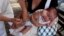 A mother holds her baby as he receives a pneumococcal vaccination during a national vaccination campaign in Managua, April 15, 2013.