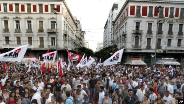 Workers take part in a rally during a protest by the PAME Communist-affiliated union in central Athens, July 20, 2011