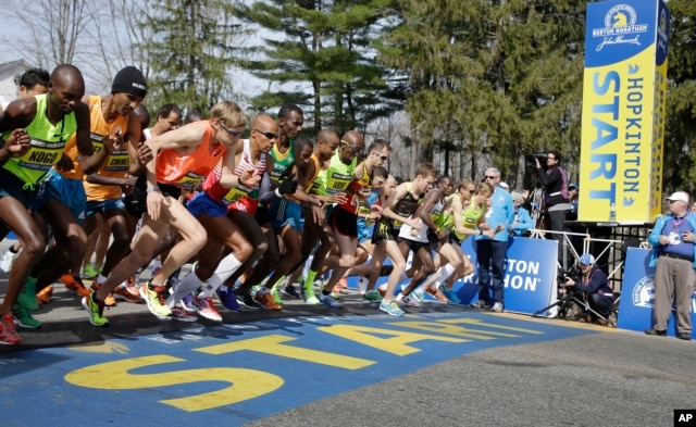 FILE - Elite men runners leave the start line in the 118th running of the Boston Marathon April 21, 2014. Fourth from left is eventual winner Meb Keflizighi