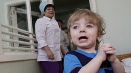 Adoption candidate Mark, 2, reacts in the children's department of a local hospital in Russia's Siberian city of Krasnoyarsk, March 23, 2011.