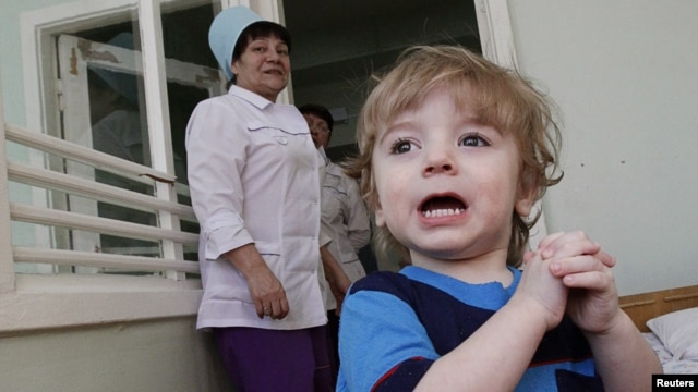 Adoption candidate Mark, 2, reacts in the children's department of a local hospital in Russia's Siberian city of Krasnoyarsk, March 23, 2011.