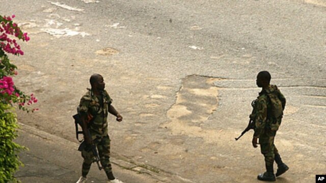Armed pro-Gbagbo soldiers patrol the streets near the presidential palace in Abidjan, April 3, 2011