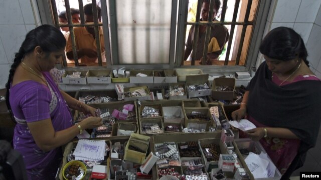 Pharmacists dispense free medication, provided by the government, to patients at Rajiv Gandhi Government General Hospital in Chennai, July 12, 2012. 