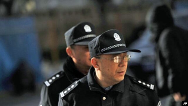 Policemen patrol outside the apartment complex where jailed Nobel peace laureate Liu Xiaobo's wife lives in Beijing, 10 Dec 2010
