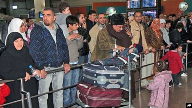 A Jordanian woman evacuated from Tripoli is received by her family as she arrives in Queen Alia Airport near Amman, Jordan, February 21, 2011