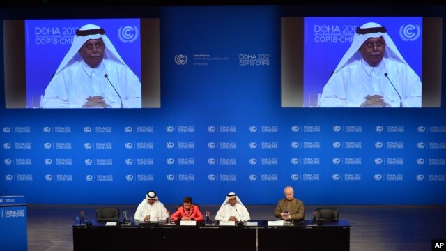UN Convention on Climate Change Executive Secretary Christiana Figueres, second left, speaks during a press conference alongside Qatar's Deputy Prime Minister and president of the 18th United Nations Convention on Climate Change, Abdullah bin Hamad Al-Attiyah, second and on screens in Doha, Qatar, Dec. 3, 2012.