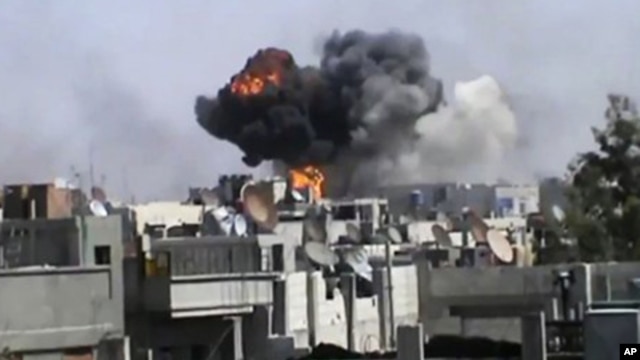 Smoke billows an impact following purported shelling in Khaldiyeh district, Homs, Syria. (file) 