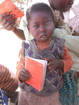 Parents and children in Malawi use health passports as a portable medical record. (Alain HY Cheng)