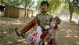 A man injured in bomb blasts is carried outside the venue of a political rally in Patna, India, Oct. 27, 2013. 