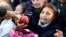 People receive free pears and apples during a protest staged by Argentine producers and farmers from the Patagonian provinces of Neuquen and Rio Negro for their losses in Buenos Aires, Argentina, Aug. 23, 2016.