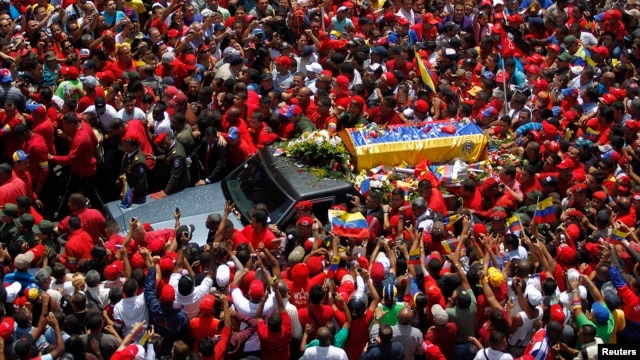 The coffin of Venezuela's late President Hugo Chavez is driven through the streets of Caracas after leaving the military hospital where he died of cancer in Caracas, March 6, 2013. 