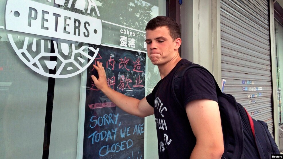 Peter Garratt, one of the sons of Canadian couple Kevin and Julia Dawn Garratt, who are being investigated in China for threatening national security, stands outside his parents' coffee shop as he talks to Reuters journalists in Dandong, Liaoning province