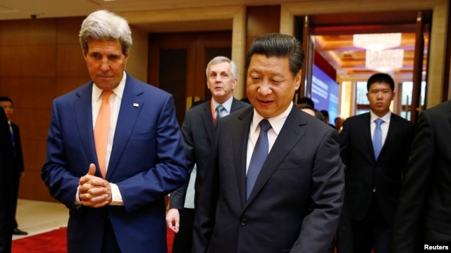 U.S. Secretary of State John Kerry (L) talks with China's President Xi Jinping after the Joint Opening Session of the U.S.-China Strategic and Economic Dialogue known as the "S&ED" at the Diaoyutai State Guesthouse in Beijing, July 9, 2014.