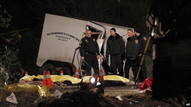 Investigators examine body bags of victims near the scene where at least eight people were killed and 38 people were injured after a tour bus carrying a group from Tijuana, Mexico crashed with two other vehicles near Yucaipa, California, February 3, 2013.
