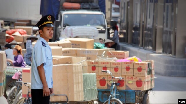 Nhân viên hải quan Việt Nam bênh cạnh hàng hóa được mua bán tại cửa khẩu Tân Thanh, Lạng Sơn. (D. Schearf/VOA)