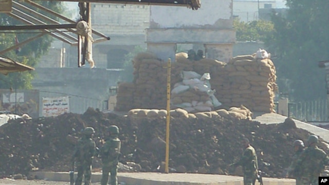Soldiers are seen at an army checkpoint in Hula, near Homs, Syria, November 4, 2011.