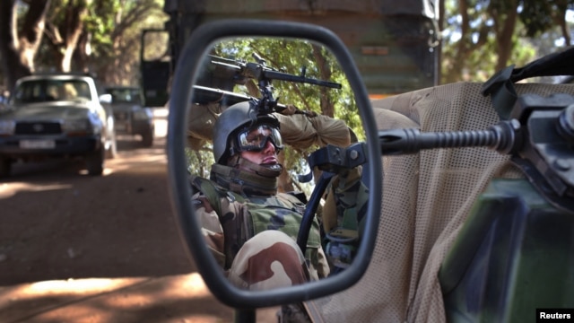 A French soldier is reflected in the mirror of a military jeep in Niono, Mali, January 20, 2013.