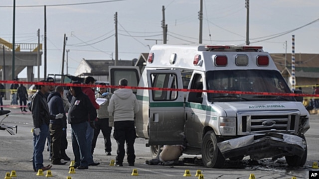 Forensic experts work on the scene after unknown gunmen opened fire on an ambulance, killing the driver, two patients and a relative of one of the patients in the northern border city of Ciudad Juarez, Mexico,  December 7, 2011.