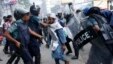 Police try to detain an activist of Hefajat-e-Islam during a clash in front of the national mosque in Dhaka May 5, 2013. At least one person was killed, more than one hundred injured, including journalists, and thirteen vehicles torched as activists from 
