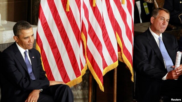 U.S. President Barack Obama, with GOP House Speaker John Boehner, at a ceremony in the U.S. Capitol in Washington, February 27, 2013. 