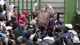 An immigration official addresses Zimbabweans outside an immigration office in downtown Johannesburg, South Africa, December 15, 2010, as they attempt to become legal.