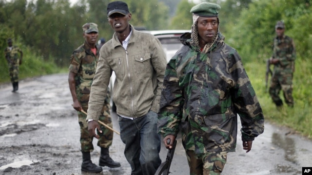 Congolese M23 rebel soldiers are seen on the road to Rushura, some 25 kilometers north of Goma, Nov. 22, 2012. 