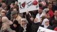 Crowd members hold signs showing support for Turkish President Recep Tayyip Erdogan at the inauguration of the Diyanet Center of America in Lanham, Maryland, April 2, 2016.