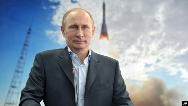Russian President Vladimir Putin listens during a live video link with the International Space Station, April 12, 2013. 