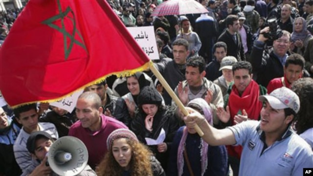 Protesters wave the Moroccan flag in Rabat, Morocco, February 20, 2011