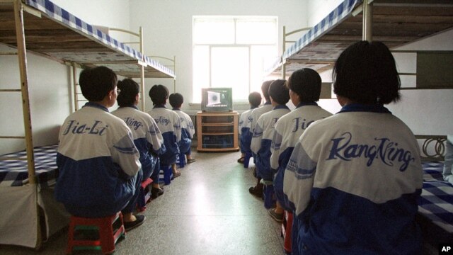Falun Gong practitioners watch a video about a solar eclipse, part of deprogramming efforts enforced at the Masanjia Reeducation-through-labor camp in northeast China's Liaoning province. (file photo)