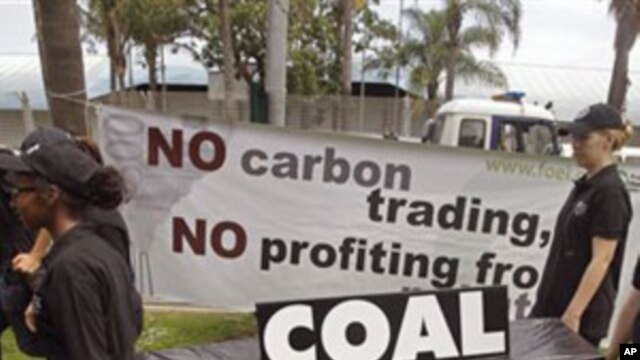 People walk with a coffin as they protest against the usage of coal during a climate change conference at the city of Durban, South Africa, Thursday, Dec 1, 2011.  (AP Photo/Schalk van Zuydam)