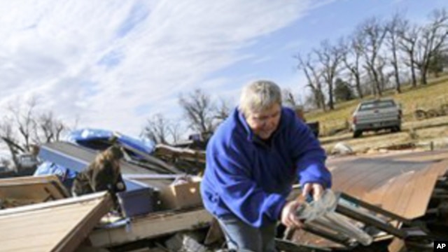 Margie Sisemore cleans after a tornado destroyed several homes in the small town of Cincinnati, Arkansas. That tornado was among 1,600 that crisscrossed the US in 2011.