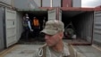 A police officer stands guard as investigation officers look inside a recently opened container holding military equipment aboard the North Korean-flagged freighter Chong Chon Gang, at the Manzanillo International container terminal on the coast of Colon 