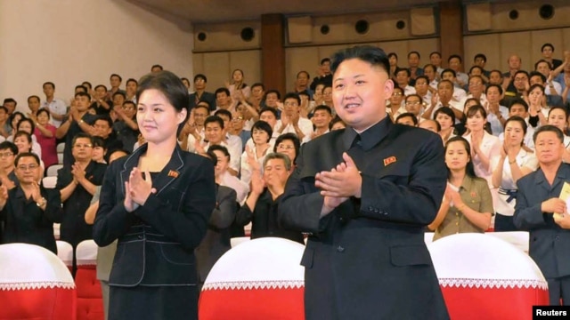 North Korean leader Kim Jong-Un (R) applauds with his wife Ri Sol-Ju (L) during a demonstration performance by the newly formed Moranbong band in Pyongyang in this undated picture released by the KCNA July 9, 2012