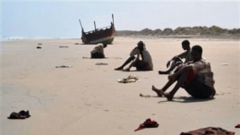 In this image released by UNHCR, unidentified refugees rest on an undisclosed beach in Yemen in March 2007. Many Ethiopians and Somalis hire smugglers to get them to Yemen. However, many are robbed, abused and some even thrown overboard. 