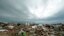 Storm clouds build in the distance beyond tornado-ravaged homes in Moore, Oklahoma, May 21, 2013.