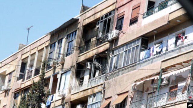 Damaged houses are seen during a heavy firefight that broke out between rebels and the Syrian government army at the western neighborhood of al-Mezze in Damascus, March 19, 2012