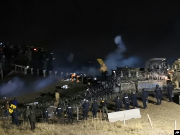 In this image provided by Morton County Sheriff’s Department, law enforcement and protesters clash near the site of the Dakota Access pipeline, Nov. 20, 2016.